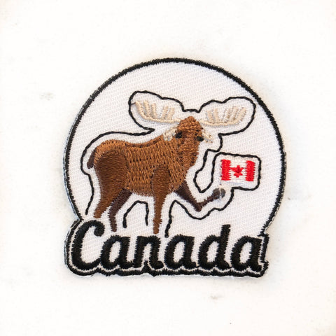 Iron on patch with Canadian moose holding a Canadian flag
